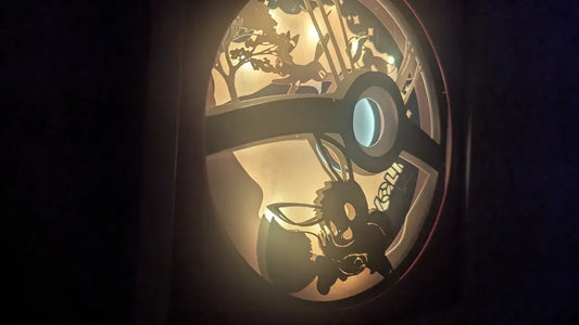 Shadowbox Évoli éclairée, création lumineuse Pokémon en papier.