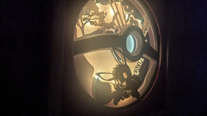 Shadowbox Évoli éclairée, création lumineuse Pokémon en papier.