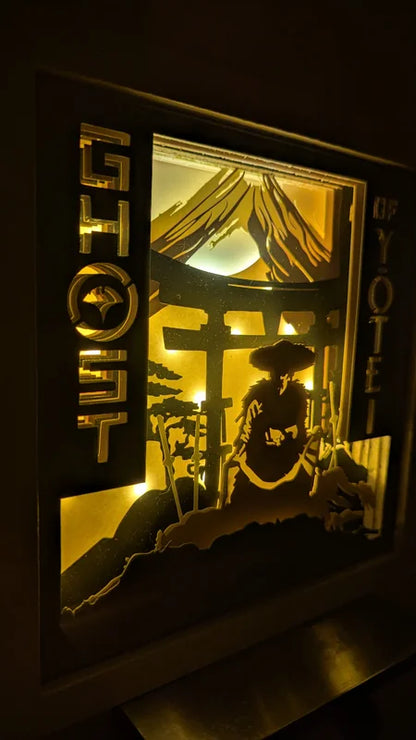Éclairage des lettres Ghost of Yotei sur la lightbox en papier découpé