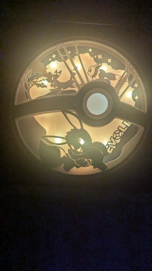Lightbox Évoli artisanale en papier, décoration Pokémon lumineuse multicouche.