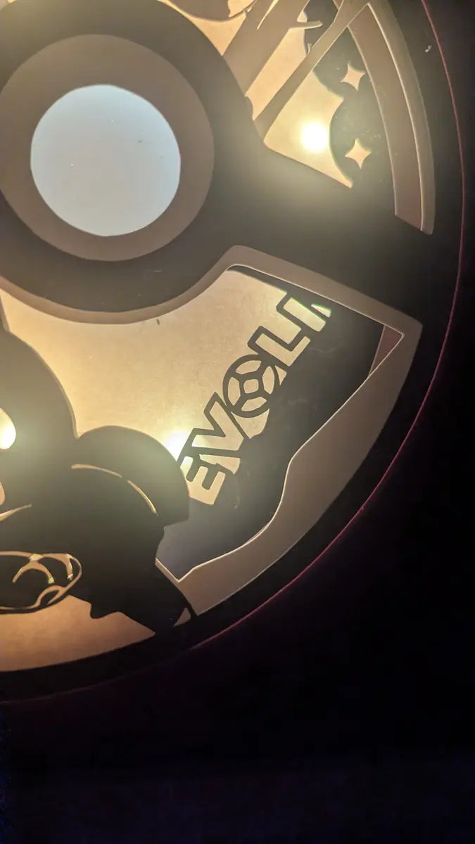 Cadre Pokémon Évoli en papercut, lightbox décorative illuminée.