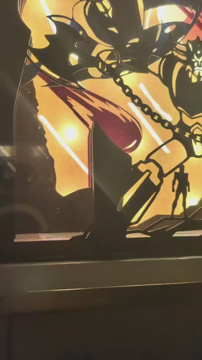 Vidéo panoramique fluide d'une lightbox Goldorak artisanale en papier découpé, révélant progressivement la scène de combat du robot emblématique sur un fond lumineux et dynamique.